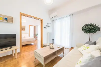 a living room with a couch and a table at Ble Elia Acropolis 2bdr Suite in Athens