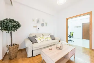 a living room with a couch and a table at Ble Elia Acropolis 2bdr Suite in Athens
