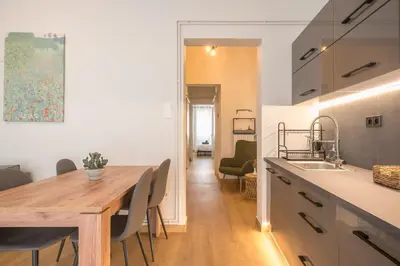 a kitchen and dining room with a wooden table at Platon At Philopappou By Greece Apartments in Athens