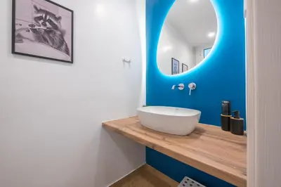 a bathroom with a white sink and a mirror at Platon At Philopappou By Greece Apartments in Athens