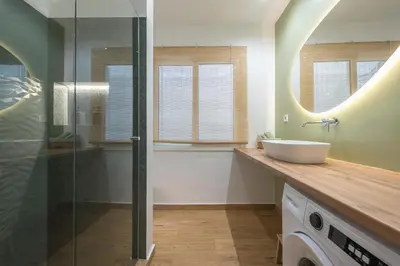 a bathroom with a sink and a glass shower at Platon At Philopappou By Greece Apartments in Athens