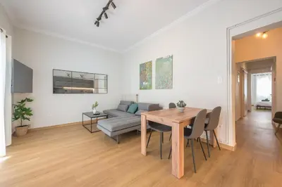 a living room with a table and a couch at Platon At Philopappou By Greece Apartments in Athens
