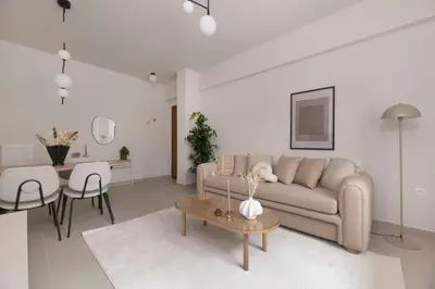 a living room with a couch and a table at Minimal Luxury Apartments in Kolonaki by UPSTREET in Athens