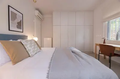 a bedroom with a large bed and a desk at Minimal Luxury Apartments in Kolonaki by UPSTREET in Athens