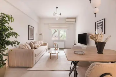 a living room with a couch and a table at Minimal Luxury Apartments in Kolonaki by UPSTREET in Athens