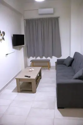 a living room with a couch and a coffee table at Cozy Mirror Apartment in Athens