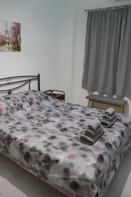 a bedroom with a bed with two towels on it at Cozy Mirror Apartment in Athens