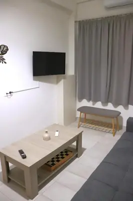 a living room with a couch and a coffee table at Cozy Mirror Apartment in Athens