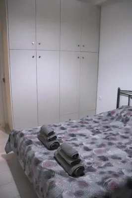 a bedroom with a bed with towels on it at Cozy Mirror Apartment in Athens
