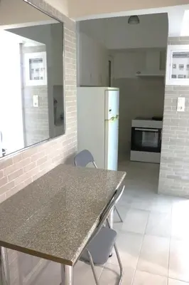 a kitchen with a table and chairs and a refrigerator at Cozy Mirror Apartment in Athens
