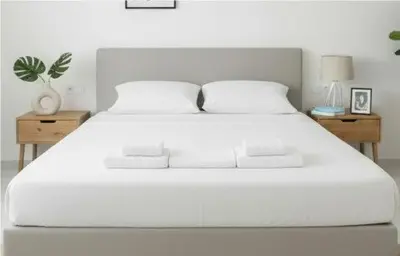 a bedroom with a white bed with two night stands at Amazing Apt with 2 Bedrooms in Pagkrati in Athens