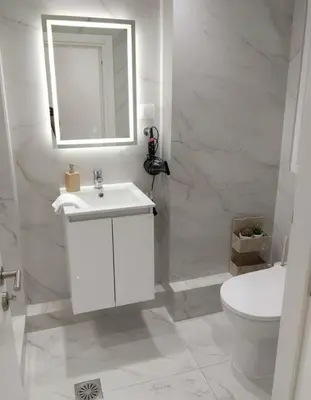 a bathroom with a sink and a toilet and a mirror at Amazing Apt with 2 Bedrooms in Pagkrati in Athens