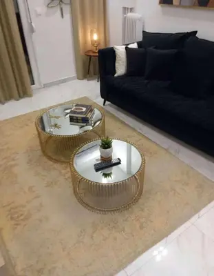a living room with a couch and a coffee table at Amazing Apt with 2 Bedrooms in Pagkrati in Athens