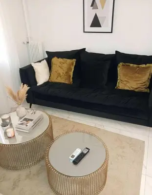 a living room with two tables and a couch at Amazing Apt with 2 Bedrooms in Pagkrati in Athens