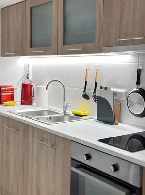 a kitchen counter with a sink and utensils at Glyfada Sea Breeze Loft A in Athens