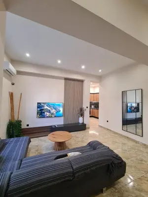a bedroom with a large bed and a table at Moda home 3siblings in Athens
