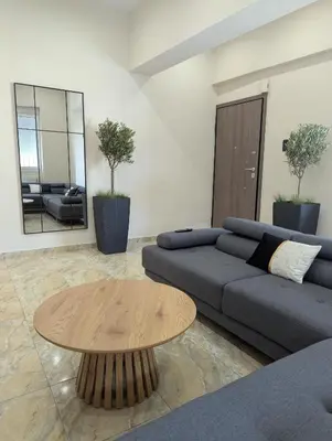 a living room with a couch and a table at Moda home 3siblings in Athens