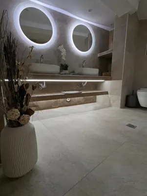 a bathroom with two sinks and two mirrors at Moda home 3siblings in Athens