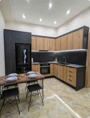 a kitchen with a table and chairs and a fireplace at Moda home 3siblings in Athens