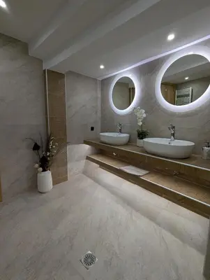a bathroom with two sinks and two mirrors at Moda home 3siblings in Athens