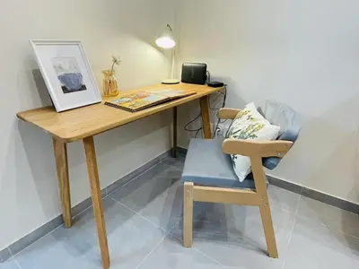 a wooden desk with a chair and a picture at \u6d77\u98ce\u5c0f\u61a9 Seabreeze Haven in Athens