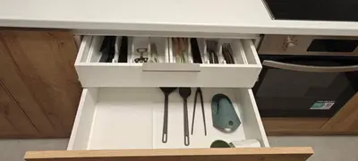 a white cabinet with a drawer with tools in it at \u6d77\u98ce\u5c0f\u61a9 Seabreeze Haven in Athens