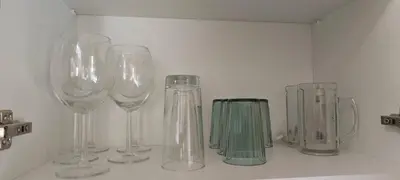 a row of wine glasses sitting on a shelf at \u6d77\u98ce\u5c0f\u61a9 Seabreeze Haven in Athens