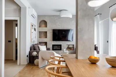 a dining room and living room with a table and chairs at Syntagma Acropolis View Residence in Athens