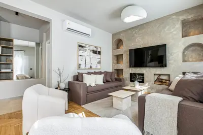 a living room with a couch and a fireplace at Syntagma Acropolis View Residence in Athens