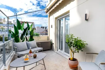 a balcony with a table and chairs on a balcony at Syntagma Acropolis View Residence in Athens