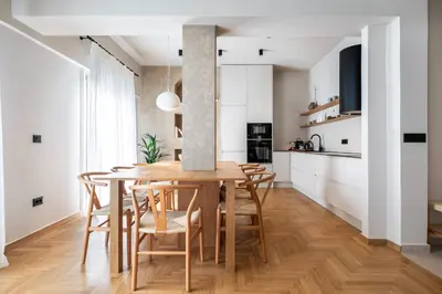 a kitchen and dining room with a wooden table and chairs at Syntagma Acropolis View Residence in Athens