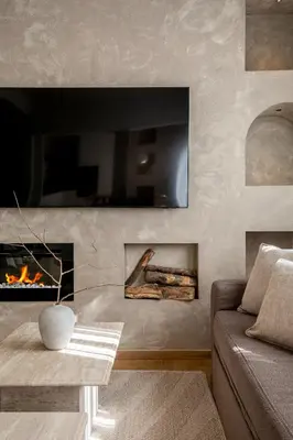 a living room with a couch and a fireplace at Syntagma Acropolis View Residence in Athens