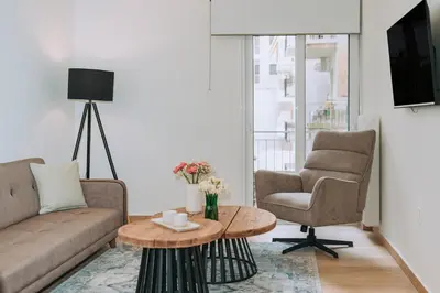 a living room with a couch and two chairs and a table at Coastal Charm Elegant 1BR at Marina Zea Piraeus in Piraeus