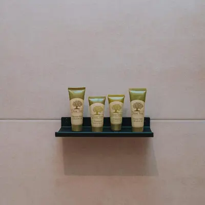 a shelf with four cups on a wall at Coastal Charm Elegant 1BR at Marina Zea Piraeus in Piraeus