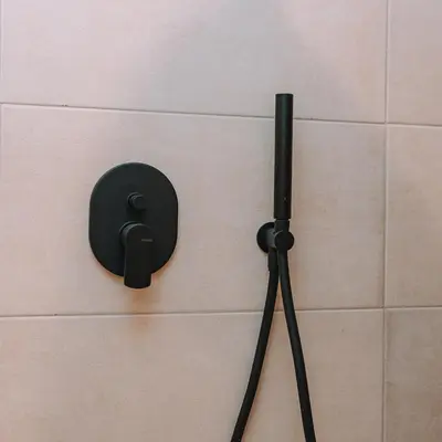 a black object is hanging on a wall at Coastal Charm Elegant 1BR at Marina Zea Piraeus in Piraeus