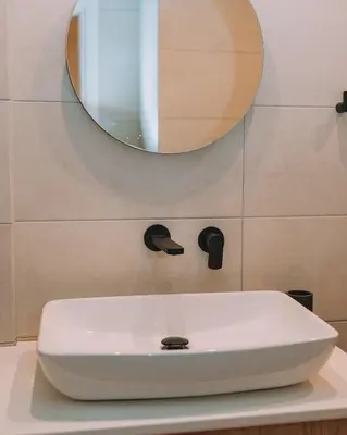 a white sink in a bathroom with a mirror at Coastal Charm Elegant 1BR at Marina Zea Piraeus in Piraeus