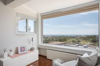 a living room with a large window with a view at LaGon Luxury Villa in Foinikiá