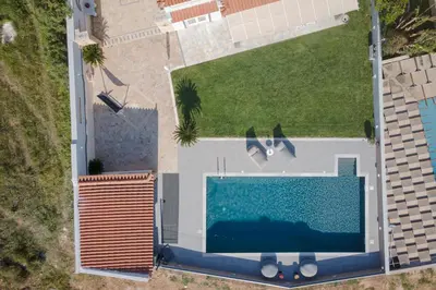 an overhead view of a swimming pool next to a building at LaGon Luxury Villa in Foinikiá