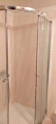 a shower with a glass door in a bathroom at Lovely apartment in Acropolis museum in Athens