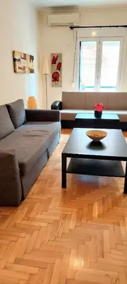 a living room with a couch and a coffee table at Lovely apartment in Acropolis museum in Athens