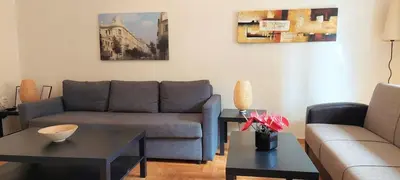 a living room with a couch and a table at Lovely apartment in Acropolis museum in Athens