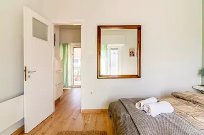 a bedroom with a bed and a mirror on the wall at Cosy Apartment in the Heart of Athens in Athens