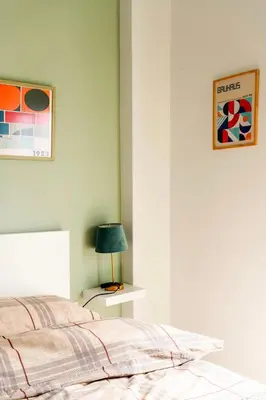 a bedroom with a bed and a table with a lamp at Cosy Apartment in the Heart of Athens in Athens