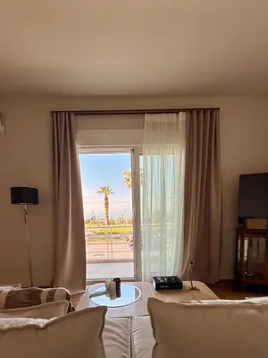 a living room with a large sliding glass door at The Seafront Niche in Athens