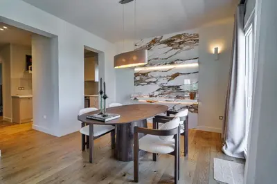 a dining room with a wooden table and chairs at The Seafront Niche in Athens