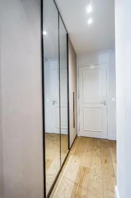 an empty room with a glass door and a wooden floor at The Seafront Niche in Athens