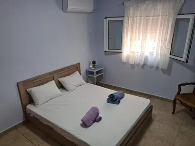 a bedroom with a bed with two towels on it at Sea View Hill House in Porto Rafti