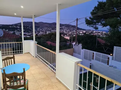 a balcony with a view of a city at Sea View Hill House in Porto Rafti
