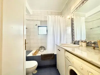 a bathroom with a sink and a toilet and a mirror at Zen house in Athenian Riviera in Athens