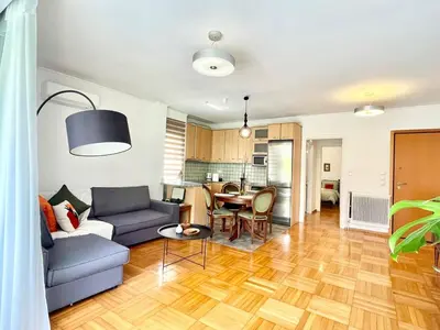 a living room with a couch and a table at Zen house in Athenian Riviera in Athens